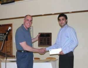 Fateh receiving award