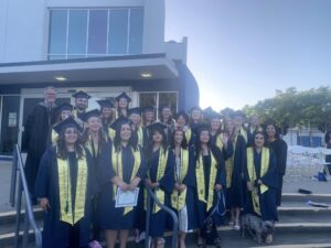 Group of people wearing graduation caps and gowns.